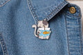Playful Cat Fishbowl Enamel Pin – Cute Cat Carrying Fish Tank Brooch – Kawaii Animal Lapel Badge – Whimsical Pet Lover Jewelry Gift